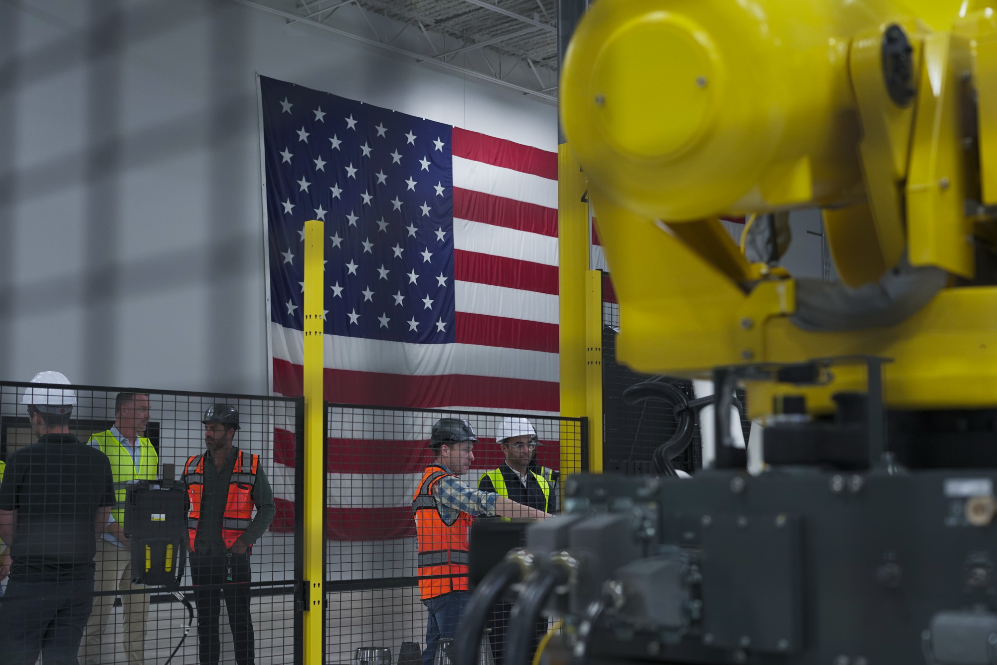 UNION operators on the Factory 01 production floor in front of a wall-sized American flag